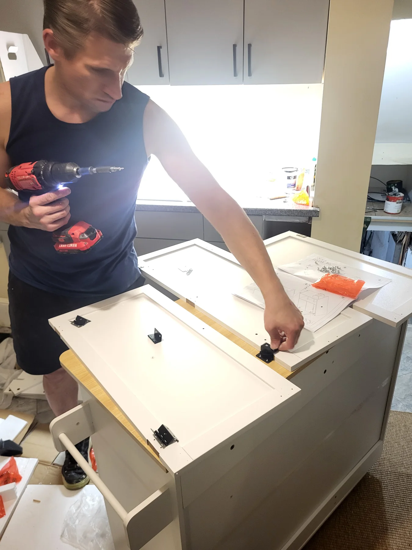 Furniture being carefully assembled from supplied parts